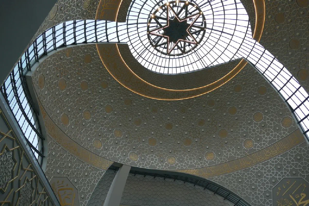 Beautiful geometric patterns and glass ceiling design in a mosque's interior.