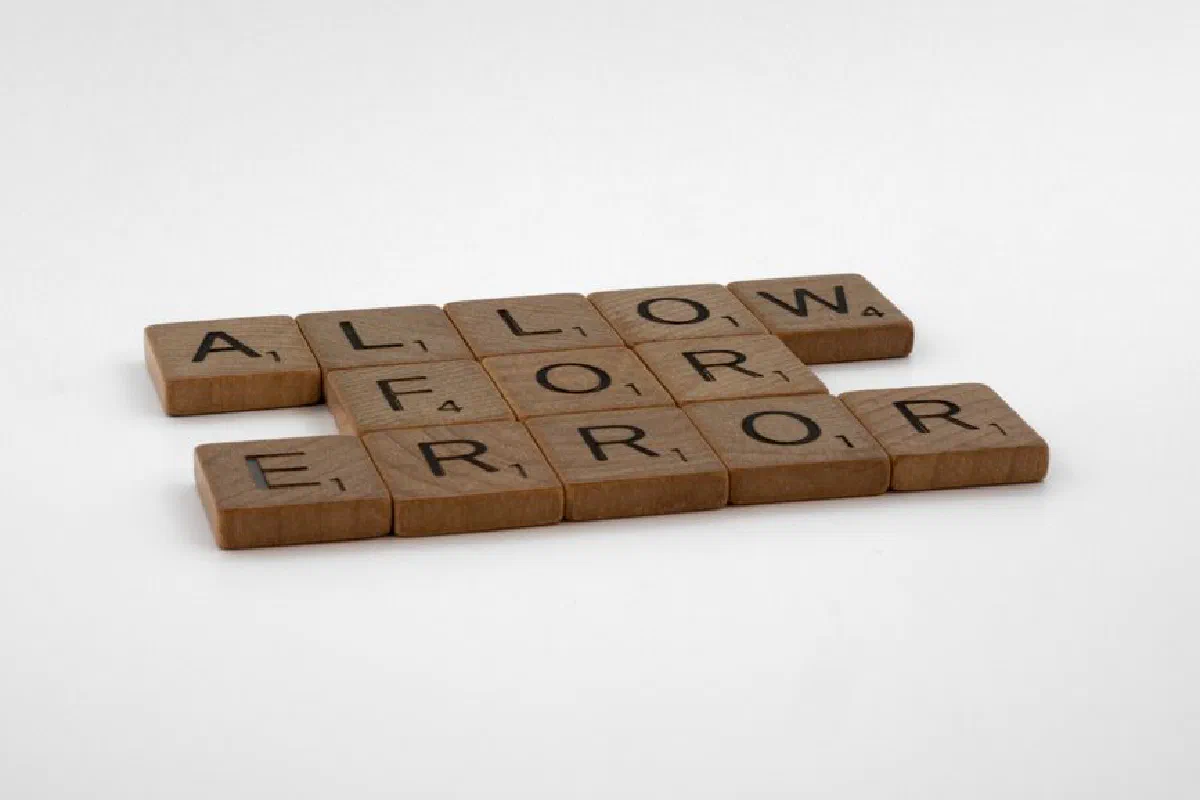 Scrabble tiles spelling 'Allow For Error' on a white background, symbolizing flexibility and acceptance.