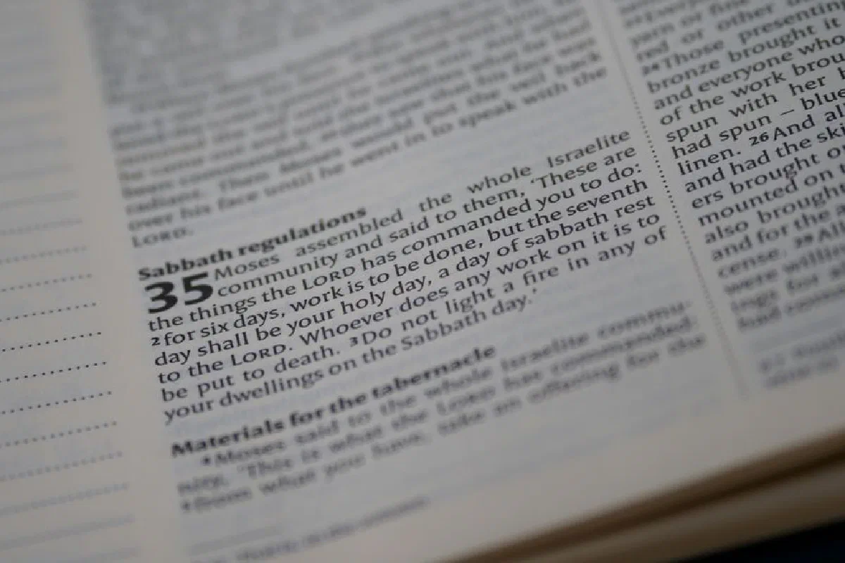 Detailed close-up of a Bible page focusing on Sabbath regulations text.