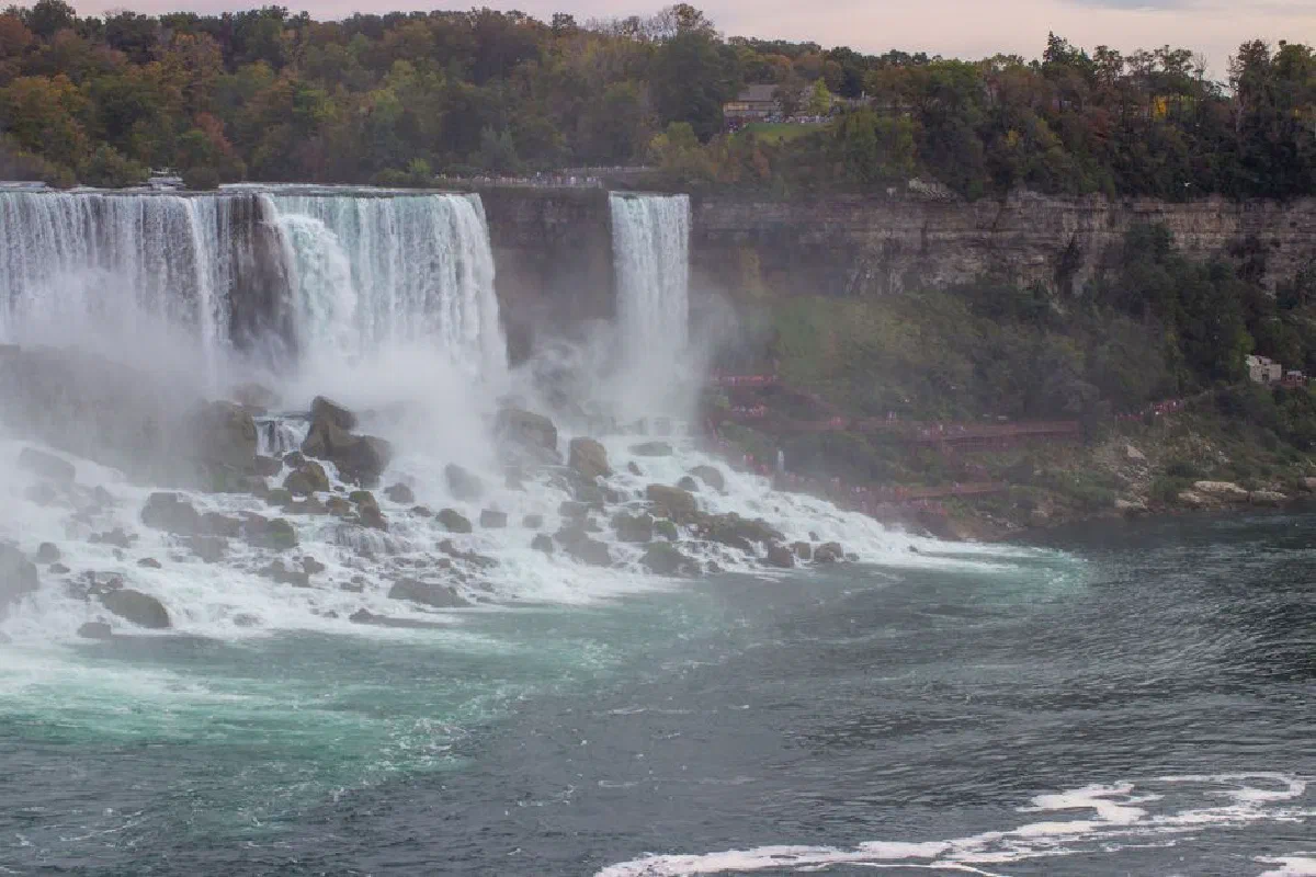 Experience the majestic beauty of Niagara Falls during the vibrant autumn season.