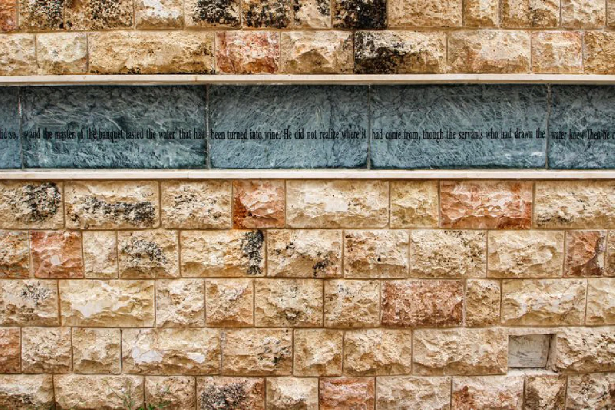 A detailed view of a stone wall engraved with text, located in Israel. Ideal for historical and architectural concepts.