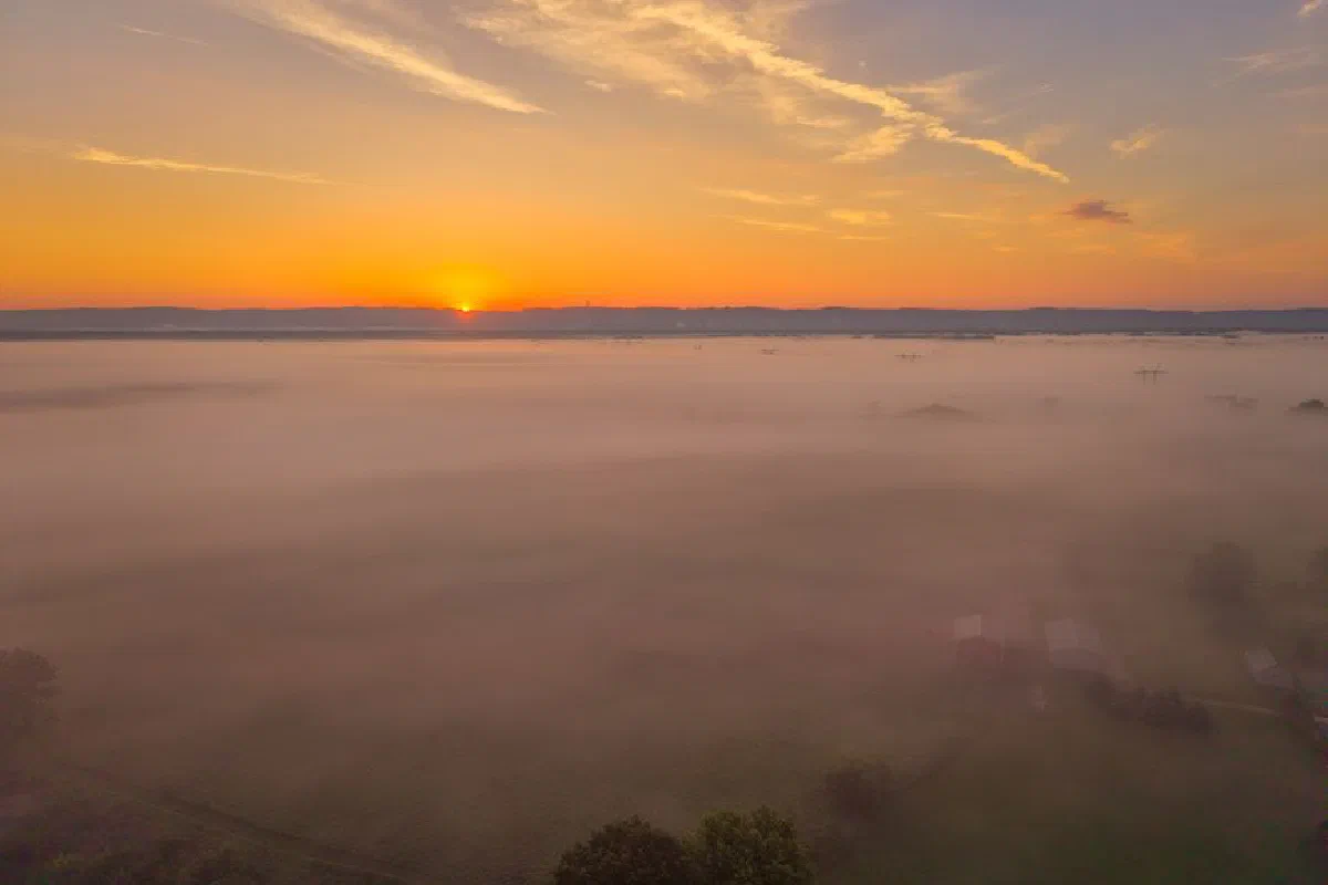 Breathtaking sunrise over misty fields in Kellogg, Minnesota, capturing a serene and atmospheric landscape.
