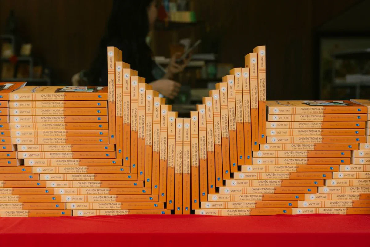 Neatly arranged books on a red cloth table in a bookstore setting.