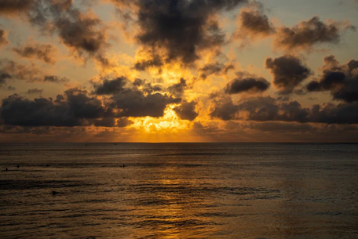 Captivating sunset view over the calm ocean waters in Bali, Indonesia.