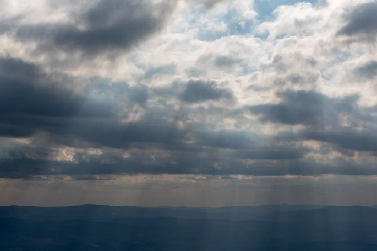 A dramatic sky with diffused clouds over the hills of Minas Gerais, Brasil, at dusk.